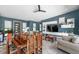 Open-concept room with dining area, modern TV, contemporary furnishings, and attractive lighting fixtures at 10722 Sumner Rd, Wimauma, FL 33598