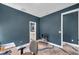 This is a view of the home office, showcasing minimalist design, unique flooring, and ample space for productivity at 10722 Sumner Rd, Wimauma, FL 33598
