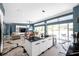 Bright open floor plan with a large kitchen island, spacious living area, and sliding glass doors at 10722 Sumner Rd, Wimauma, FL 33598