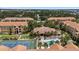 Aerial view of a well-maintained community featuring a pool, tennis court, and lush landscaping at 10764 70Th Ave # 3206, Seminole, FL 33772