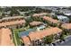 Aerial view of a well-maintained community with a pool, tennis court, lush landscaping, and convenient parking at 10764 70Th Ave # 3206, Seminole, FL 33772