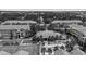 Aerial view of a well-maintained community featuring a pool, tennis court, and lush landscaping at 10764 70Th Ave # 3206, Seminole, FL 33772