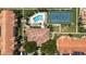 Aerial view showcasing the community pool, tennis court, and surrounding residential buildings at 10764 70Th Ave # 3206, Seminole, FL 33772