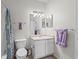Bright bathroom featuring a toilet, vanity with sink, and decorative towels at 10764 70Th Ave # 3206, Seminole, FL 33772