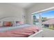 Bright bedroom featuring a pink color palette and a large window overlooking the community pool at 10764 70Th Ave # 3206, Seminole, FL 33772