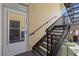 Exterior view of a condo entrance with a private staircase and well-lit entryway at 10764 70Th Ave # 3206, Seminole, FL 33772