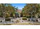 Charming building exterior with lush landscaping, fountain, and well-maintained grounds at 10764 70Th Ave # 3206, Seminole, FL 33772