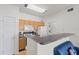 Functional kitchen with wooden cabinets, white appliances, and a breakfast bar counter at 10764 70Th Ave # 3206, Seminole, FL 33772