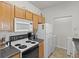 Efficient kitchen with wooden cabinetry, standard appliances, and a bright, clean design at 10764 70Th Ave # 3206, Seminole, FL 33772