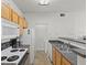 Practical kitchen with stainless steel sink, standard appliances, and wooden cabinetry at 10764 70Th Ave # 3206, Seminole, FL 33772
