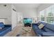 Bright living room featuring comfortable seating, a flat-screen TV, and a view of the outdoor scenery at 10764 70Th Ave # 3206, Seminole, FL 33772