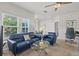 Inviting living room with a modern ceiling fan, plush blue seating, and a bright window at 10764 70Th Ave # 3206, Seminole, FL 33772