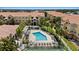 Community pool surrounded by lush landscaping and lounge chairs for relaxing and enjoying the Florida sunshine at 10764 70Th Ave # 3206, Seminole, FL 33772