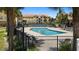 Community pool surrounded by lush landscaping providing a relaxing and refreshing atmosphere at 10764 70Th Ave # 3206, Seminole, FL 33772