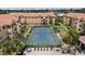 Aerial view of tennis court in a well-maintained community with beautiful landscaping at 10764 70Th Ave # 3206, Seminole, FL 33772