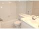 A bright bathroom featuring white tiled walls, a tub, and a white vanity at 111 Lakeview Pl, Oldsmar, FL 34677