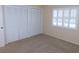 This bedroom features carpet floors, shuttered windows, and spacious closet at 111 Lakeview Pl, Oldsmar, FL 34677