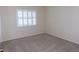 This bedroom features carpet floors, shuttered windows, and neutral paint at 111 Lakeview Pl, Oldsmar, FL 34677
