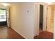 Entryway with hardwood floors and neutral walls leading to the bathroom and other rooms in the condo at 111 Lakeview Pl, Oldsmar, FL 34677
