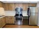 A well-lit kitchen featuring stainless steel appliances and wooden cabinets at 111 Lakeview Pl, Oldsmar, FL 34677