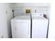 The laundry room includes a washer and dryer with overhead storage at 111 Lakeview Pl, Oldsmar, FL 34677