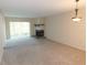 Spacious living room featuring neutral carpeting, a fireplace, and a large window for natural light at 111 Lakeview Pl, Oldsmar, FL 34677