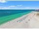 Breathtaking aerial beach view with turquoise water, white sand, and rows of beach umbrellas at 1180 Gulf Blvd # 402, Clearwater Beach, FL 33767