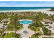 Beautiful aerial view of the beach, pool, and manicured landscaping from above at 1180 Gulf Blvd # 402, Clearwater Beach, FL 33767