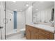 Clean bathroom design, with a glass shower, wood vanity, and white countertop at 1180 Gulf Blvd # 402, Clearwater Beach, FL 33767