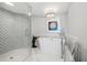 Luxurious bathroom with a freestanding tub, a glass enclosed shower, and designer finishes at 1180 Gulf Blvd # 402, Clearwater Beach, FL 33767