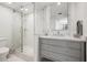 Stylish bathroom vanity with gray cabinetry and a glass-enclosed shower at 1180 Gulf Blvd # 402, Clearwater Beach, FL 33767