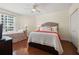 Bright bedroom featuring a queen bed, wood floors, a ceiling fan, and a seating area at 1180 Gulf Blvd # 402, Clearwater Beach, FL 33767