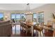Bright dining room with seating for six and sliding glass doors to a balcony with stunning ocean views at 1180 Gulf Blvd # 402, Clearwater Beach, FL 33767