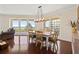 Dining room with a wooden table and chandelier and ocean views from the adjacent balcony at 1180 Gulf Blvd # 402, Clearwater Beach, FL 33767