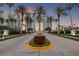 Elegant entrance with palm trees and lush landscaping leading to the Grande, creating a welcoming view at 1180 Gulf Blvd # 402, Clearwater Beach, FL 33767