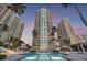Luxurious high-rise condominium complex with a sparkling swimming pool in the foreground at 1180 Gulf Blvd # 402, Clearwater Beach, FL 33767
