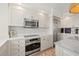 Modern kitchen features stainless steel appliances, white cabinets, and sleek countertops at 1180 Gulf Blvd # 402, Clearwater Beach, FL 33767