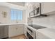Bright kitchen with stainless steel appliances, white cabinetry, and a stylish backsplash, providing a clean and modern feel at 1180 Gulf Blvd # 402, Clearwater Beach, FL 33767