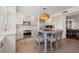 Well-lit kitchen showcasing white cabinetry, stainless steel appliances, and a charming center island with seating at 1180 Gulf Blvd # 402, Clearwater Beach, FL 33767