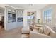 Cozy living room with custom built-ins, comfortable seating, and sliding glass doors to a balcony overlooking the beach at 1180 Gulf Blvd # 402, Clearwater Beach, FL 33767
