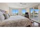 Spacious main bedroom with a king-size bed and a sliding glass door to a balcony overlooking the beach at 1180 Gulf Blvd # 402, Clearwater Beach, FL 33767