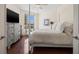 Relaxing main bedroom with a four-poster bed, a gray dresser and views of the pool and beach at 1180 Gulf Blvd # 402, Clearwater Beach, FL 33767