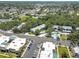 A stunning aerial view of a community with mature trees, a communal pool, and well-maintained apartment buildings at 11800 Park Blvd # 208, Seminole, FL 33772