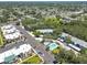 A stunning aerial view of a community with mature trees, a communal pool, and well-maintained apartment buildings at 11800 Park Blvd # 208, Seminole, FL 33772