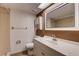 Bathroom with vanity, mirror, tiled shower and tile floors at 11800 Park Blvd # 208, Seminole, FL 33772