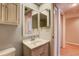Comfortable bathroom with a mirrored medicine cabinet and vanity with storage at 11800 Park Blvd # 208, Seminole, FL 33772