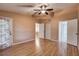 Comfortable bedroom boasts hardwood floors, ceiling fan, and ensuite bathroom at 11800 Park Blvd # 208, Seminole, FL 33772