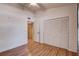 Bedroom features wood floors, ceiling fan, and large closet with bi-fold doors at 11800 Park Blvd # 208, Seminole, FL 33772