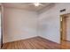Bedroom features wood floors, ceiling fan, and ensuite bathroom at 11800 Park Blvd # 208, Seminole, FL 33772