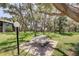 Inviting common area featuring picnic tables, lush landscaping, and mature trees, perfect for outdoor enjoyment at 11800 Park Blvd # 208, Seminole, FL 33772